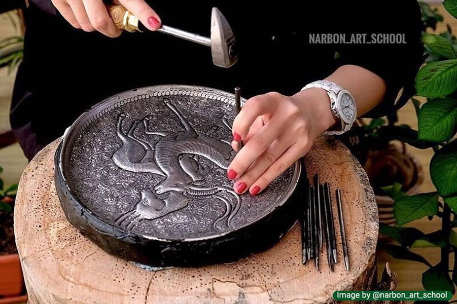 Toreutics on silver trays using traditional tools